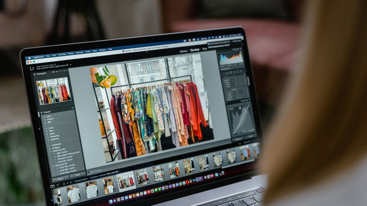 A laptop showing product photos of a clothes rack in an editing program
